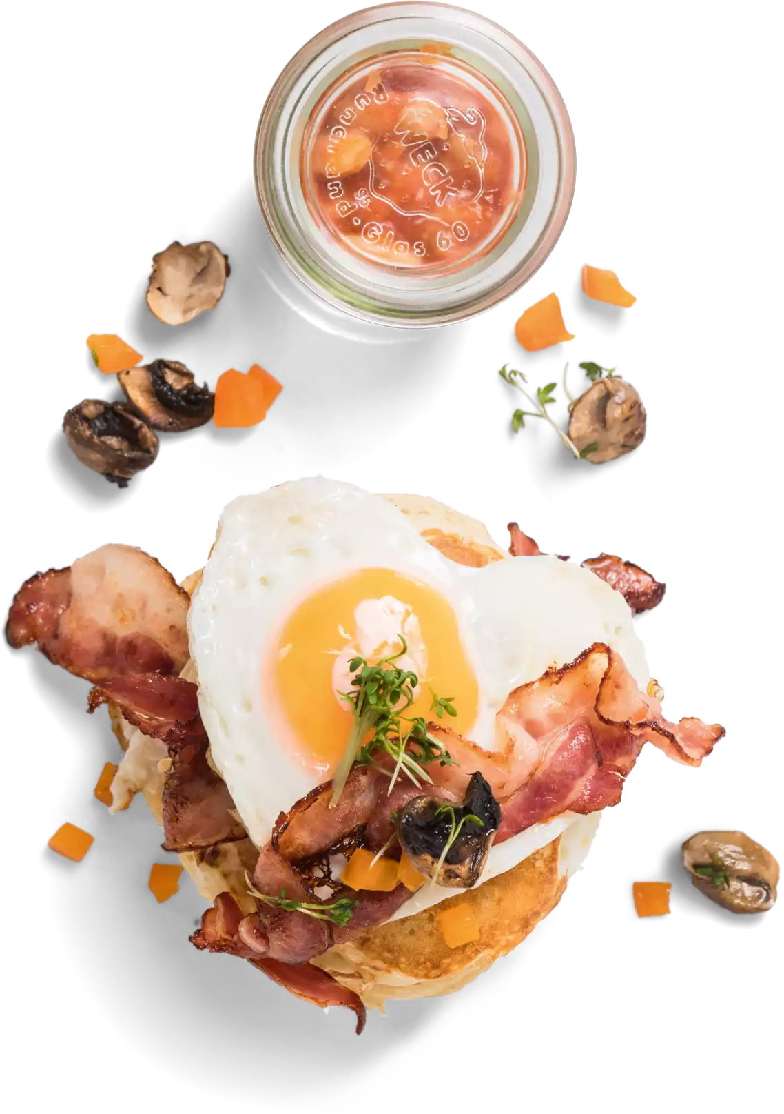 Heart-shaped fried egg on pancakes with bacon and baked beans in a small jar – a California Bean signature dish
